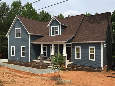 blue house with brown metal roof|brown house white trim.